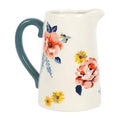 White ceramic flower jug with teal handle and floral plus bee graphics on front