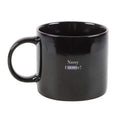 Black ceramic mug with 'Nosy CENSORED!' text and curved handle