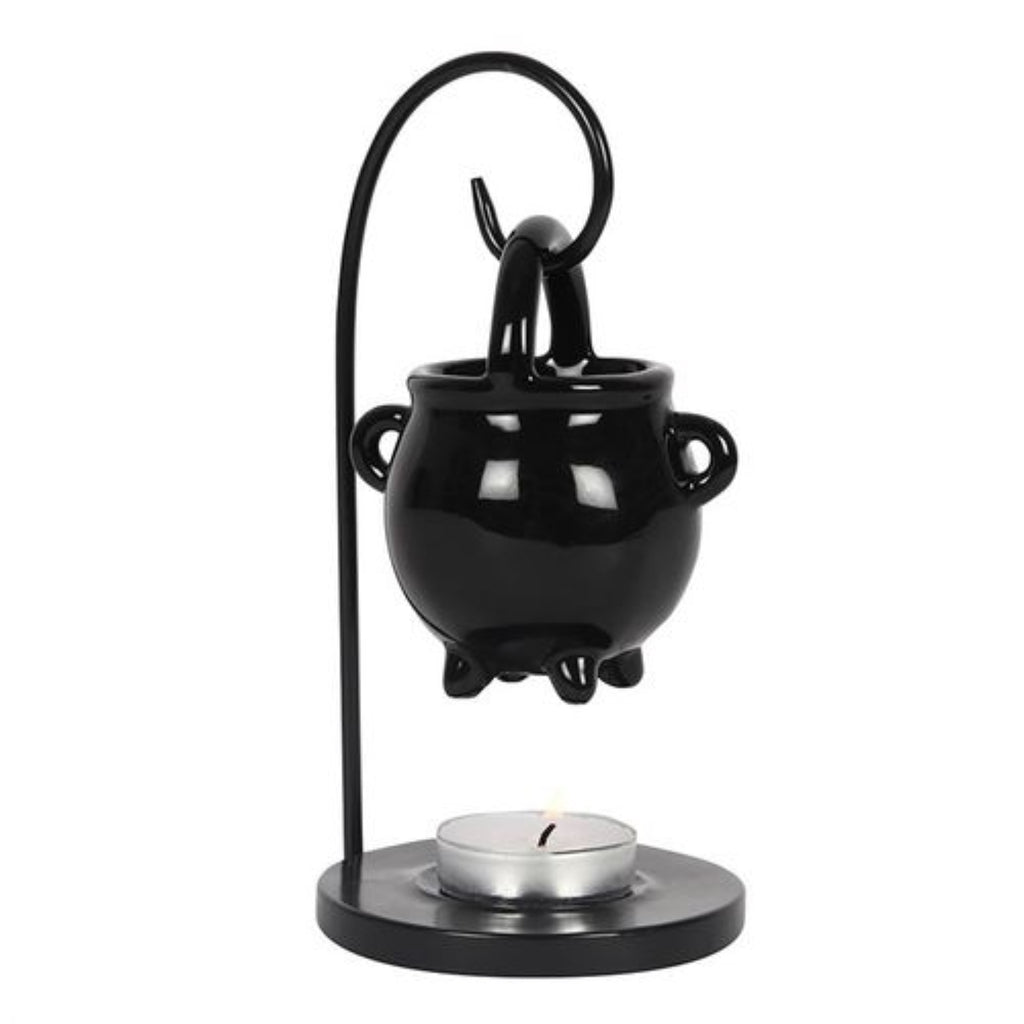 Black cauldron-shaped candle holder with a candle on a white background