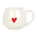 Rounded white ceramic mug with a red heart on the front