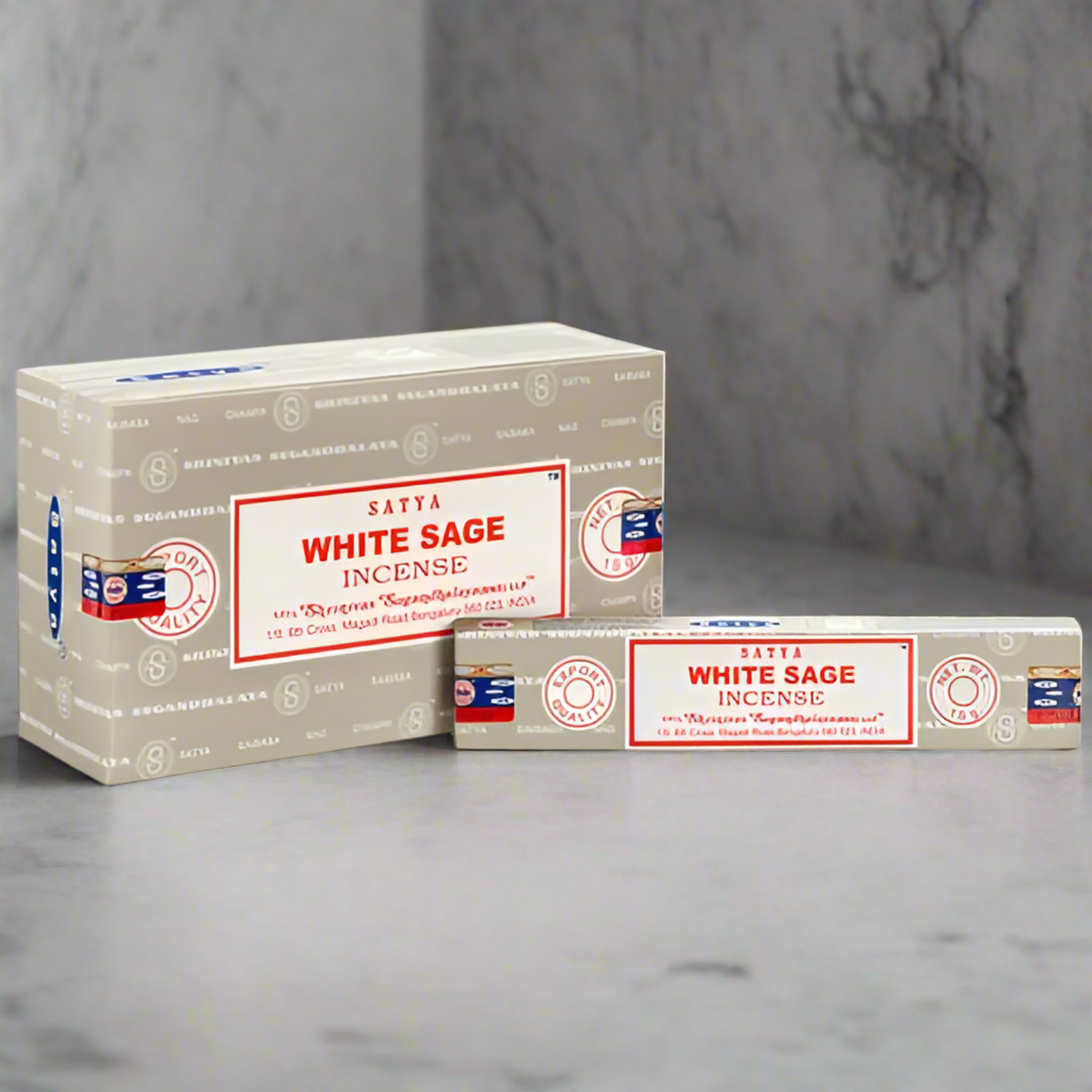 Two boxes of Satya White Sage Incense on a gray surface with a marble background