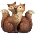 Hand-painted fox figurine pair with carved patterns, hugging pose and curled tails.