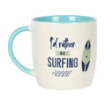Ceramic mug with light cream body, turquoise rim, and 'Be Surfing' surfboard graphic