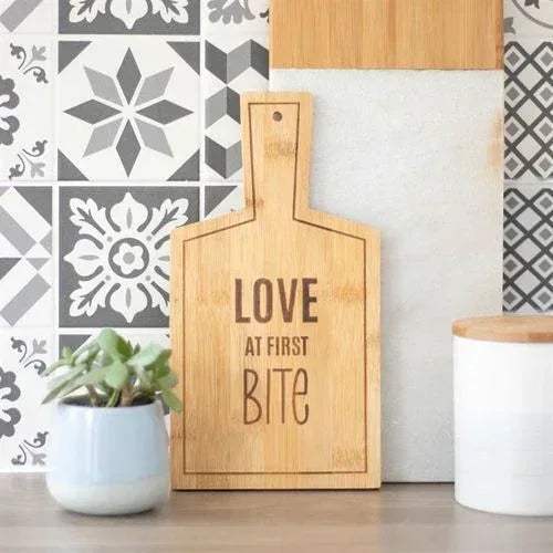 Bamboo serving board with LOVE AT FIRST BITE text, upright