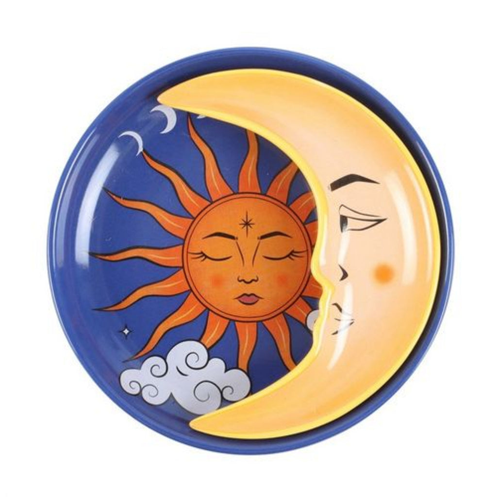Decorative plate with sun and moon design on a white background