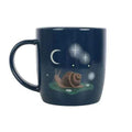 Dark blue ceramic mug with snail, moon, and stars night print; side handle