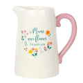 White ceramic flower jug with pink handle and floral message on front