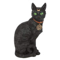 Sitting black cat figurine with green eyes, orange collar and gold pentacle pendant
