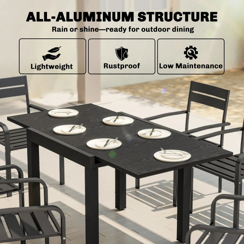 Black aluminium outdoor dining table with faux wood slatted top and pedestal legs
