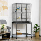 Large black bird cage with stand and lower wire shelf; two colorful birds inside