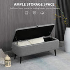 Grey flip-top storage ottoman with open compartment, linen-look fabric and steel legs