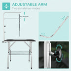 Foldable pet grooming table with adjustable arm above black anti-slip tabletop and lower rack