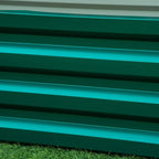 Green raised planter wall with horizontal slat panels and clean edges