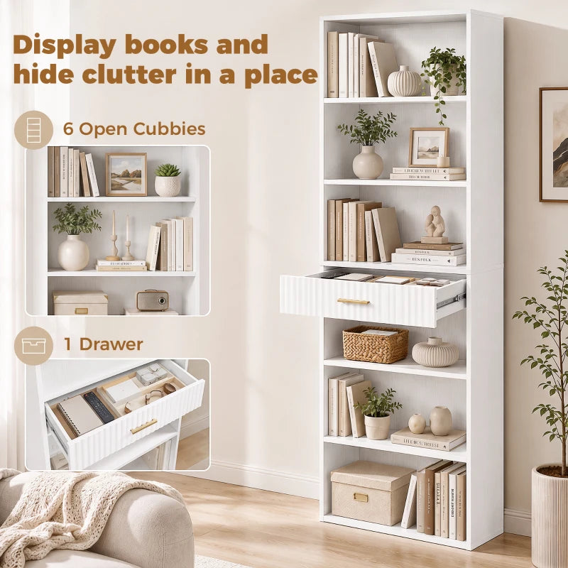 White tall bookcase with open cubbies and a drawer, styled with books
