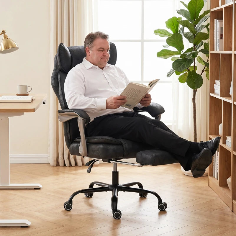 Black reclining office chair with wide seat and tall backrest, shown in use