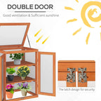 Wood greenhouse cold frame with double doors open, tiered shelves, and potted plants