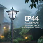 Black outdoor solar lamp post with lantern head under falling rain