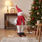 Decorative skiing Santa figure in red outfit with striped scarf, holding ski poles