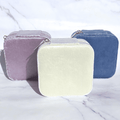 Jewelry travel case set of three mini zip pouches in lavender, cream, and dusky blue.