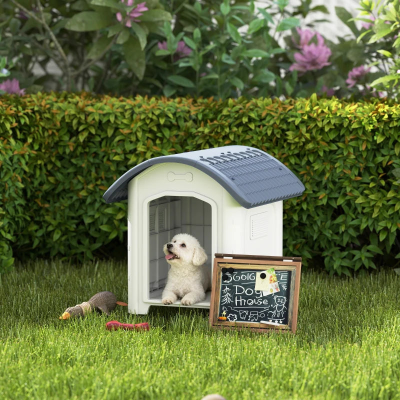 Outdoor dog kennel with dark grey roof and white plastic walls, open front doorway
