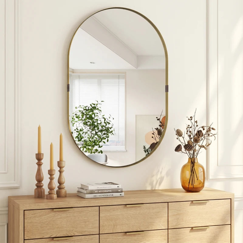 Gold-tone oval wall mirror with thin raised frame and centered round glass