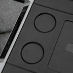 Close-up of black cooler panel with two round ports and recessed connector area