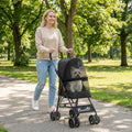 Black foldable pet stroller with mesh window, hand-held handle, and multi-wheel base