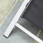 Sun lounger frame close-up with dark mesh underside and non-slip foot pad