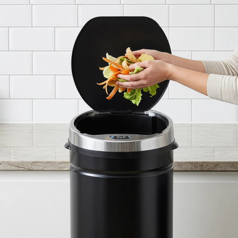 Black round motion sensor bin with open lid and visible waste inside