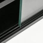 Close-up of black cabinet frame and glass door edge with clear tempered panel