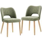 Set of 2 green upholstered dining chairs with curved backs, foam seats, and light wood legs