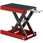 Red motorcycle scissor jack with black anti-slip deck and silver lift handle, side view