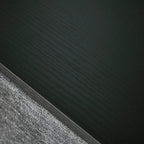 Close-up of grey fabric drawer edge with dark trim along the frame seam