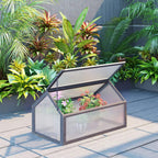 Grey cold frame greenhouse with open top showing plant bed inside
