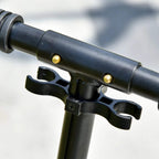 Silver kick scooter handlebar clamp with black lever and rubber grip ends.