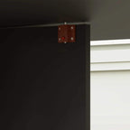 Black drop-leaf dining table hinge latch on the underside frame