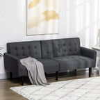 Grey fabric sofa bed with tufted backrest, padded armrests, and dark tapered legs
