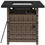Brown woven fire pit table with black tabletop and side access door handle