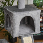 Grey plush hammock bed panel with raised sides on cat tree, beige trim visible