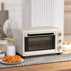 Cream mini countertop oven with glass door and right-side control knobs