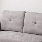 Light grey sofa backrest with three tufted panels and padded arm sections