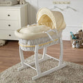 Wicker baby moses basket on white stand with cream bedding and hooded liner