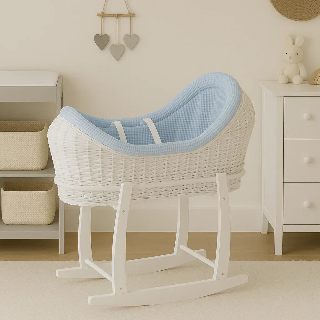 White wicker baby moses basket with stand and light blue textured bedding