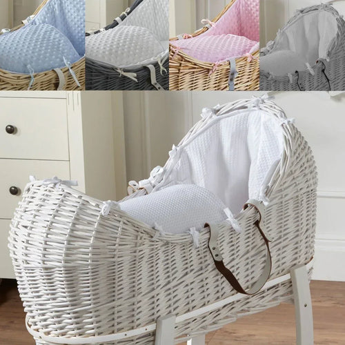 White wicker baby Moses basket with white textured cushion and padded cover