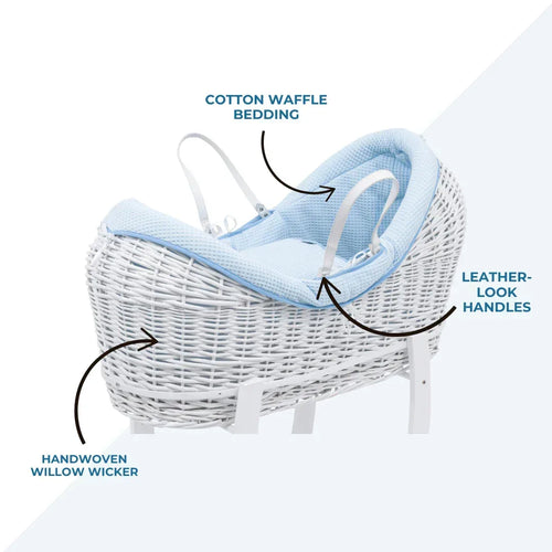 White wicker Moses basket with blue waffle bedding and leather-look handle straps