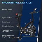 Black stationary bike details: anti-slip handle, ergonomic seat, bottle holder, toe-pedal cages