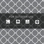 Gray and white trellis-pattern outdoor rug surface, close-up textured weave
