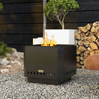 Black square metal fire pit with open top and vent holes, burning flame outdoors