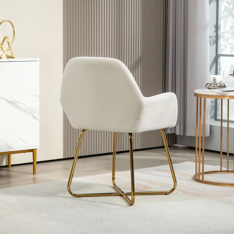 Cream upholstered accent chair with curved back and armrests, supported by gold metal sled legs