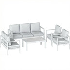 White outdoor sofa set with gray cushions, matching armchairs, and rectangular coffee table